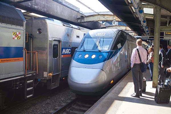 Real-life American humans waiting to ride a high-speed rail train (!!!).