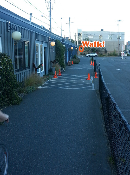 Eastbound view, with crosswalk displaying walk symbol.
